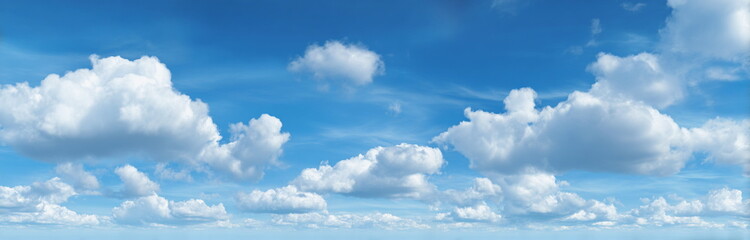 Obraz premium Beautiful blue sky with fluffy white clouds, creating a calm and serene atmosphere for nature and travel themes.