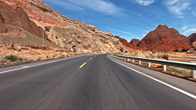 Driving a car through Danxia landform mountain valley in Xinjiang, China.