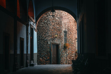 Colonial Courtyard Arch Weathered Stone Wall and wood doors in Guanajuato Mexico, atmospheric Alley in an Old mexican Town with cinematic Lighting