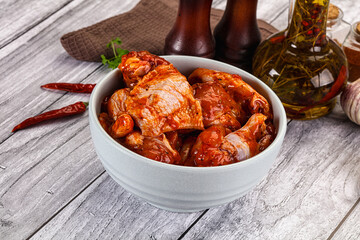 Raw marinated buffalo chicken wings
