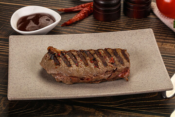 Grilled beef striploin steak with sauce