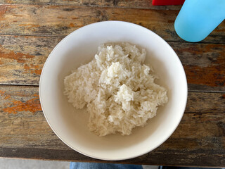 a closeup shot of a white bowl with a rice