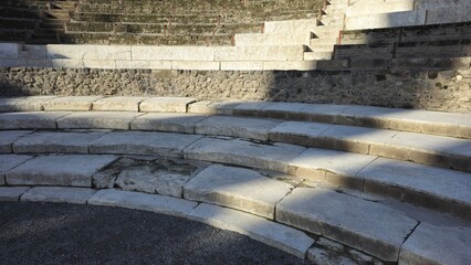 Pompeii Grand Theatre, Italy - 8 January 2025. Curved stone seating tiers with weathered steps and...