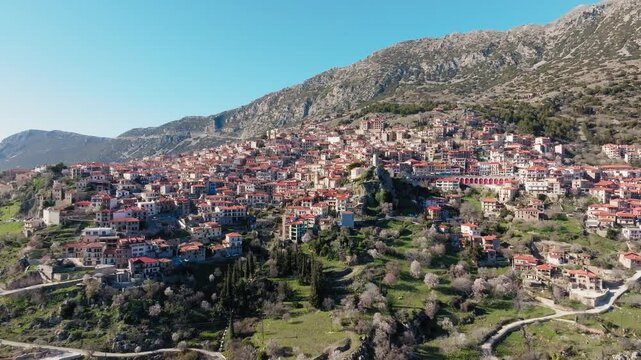 Aerial view of Arachova mountain town uphill houses, Boeotia, Drone shot, Establishing