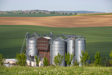 Modern metal silos on agro-processing and manufacturing plant.