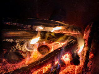 Night photo of bonfire. Closeup photography of flame of burning wood on black background.