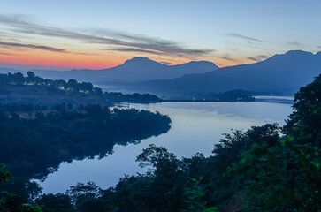 Serene landscape at dawn with mist and fog in Bhandardara, Maharashtra, India. Soft focus