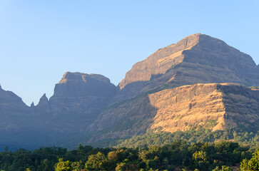 Serene landscape at dawn with mist and fog in Bhandardara, Maharashtra, India. Soft focus