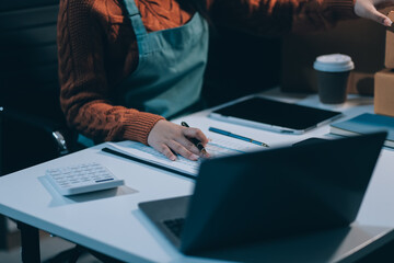 Startup SME small business entrepreneur of freelance Asian woman wearing apron using laptop and box...