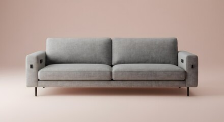 Naklejka premium Studio shot of a grey modern sofa against a pink background
