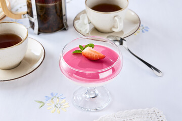 Raspberry souffle dessert with strawberry garnish, bright lighting, overhead composition