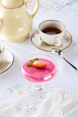 Raspberry souffle dessert with fresh strawberry garnish, bright natural light, overhead composition
