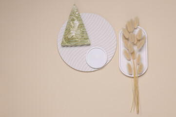 Composition of plaster figures with dried flowers of lagurus. Moodboard for design