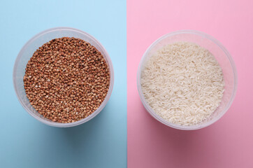 Plastic jars with buckwheat and rice on blue pink background. Top view
