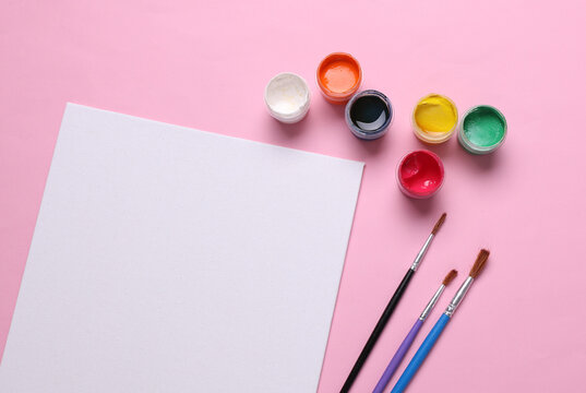 Set for drawing, children's creativity. White blank canvas, paint jars and brushes on pink background. Top view. Flat lay - Powered by Adobe