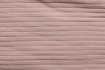 Texture of beige ribbed fabric close up