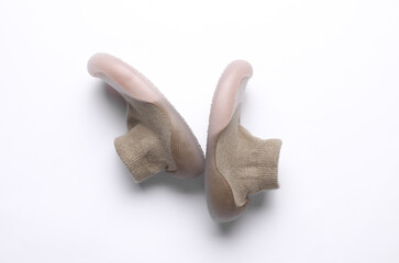 First baby shoes on white background. Top view