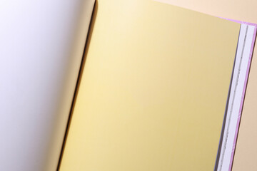Blank page of open book or magazine on a beige background. Mockup for design