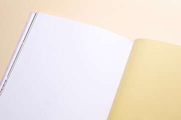 Blank page of open book or magazine on a beige background. Mockup for design