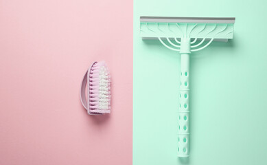 Window cleaning mop and brush on blue pink background. Top view