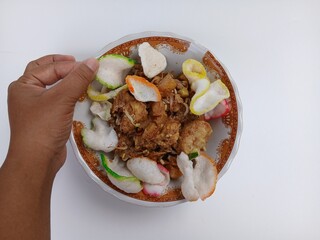 tahu telur or tahu gimbal or tahu tek or egg tofu. is a typical food of the city of Semarang. This food consists of fried tofu, chopped raw cabbage, rice cake, bean sprouts, eggs