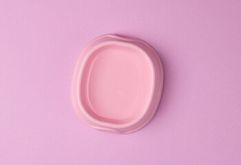 Bowl of water for drinking pets on pink background