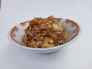 tahu telur or tahu gimbal or tahu tek or egg tofu. is a typical food of the city of Semarang. This food consists of fried tofu, chopped raw cabbage, rice cake, bean sprouts, eggs