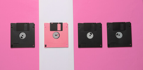 Outdated technologies. Retro floppy disk on a pink-white background. Back to the 80s. Minimalistic layout. Top view