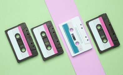Outdated technologies. Retro audio cassettes on pastel background. Back to the 80s. Minimalistic...