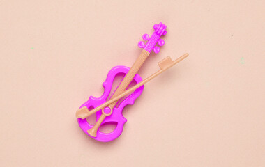 Pink Toy Violin on pastel background