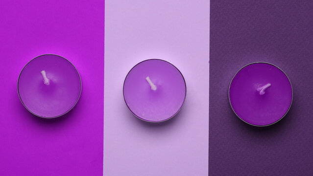 Aroma tea candles on purple colored background. Minimalistic layout, Top view