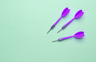 Darts needles on blue pastel background
