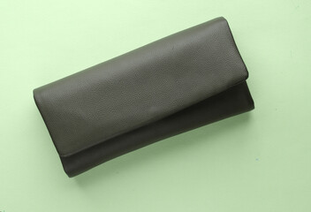 Leather fashion wallet on a mint green background
