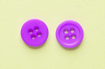Two pink buttons on a green background