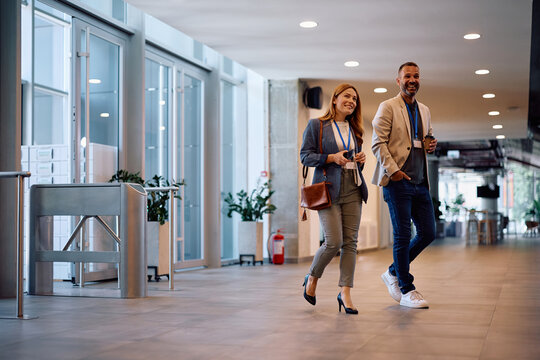 Happy business coworkers coming to work.