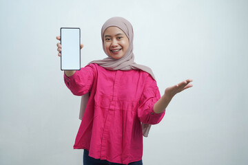 Confident Young Asian Woman in Hijab Presenting Smartphone with Blank Screen isolated on White...