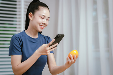 A person uses a digital tablet with a stylus over a bowl of fresh fruit, blending technology with...