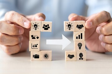 Hands arrange wooden blocks, symbolizing idea transfer and collaboration