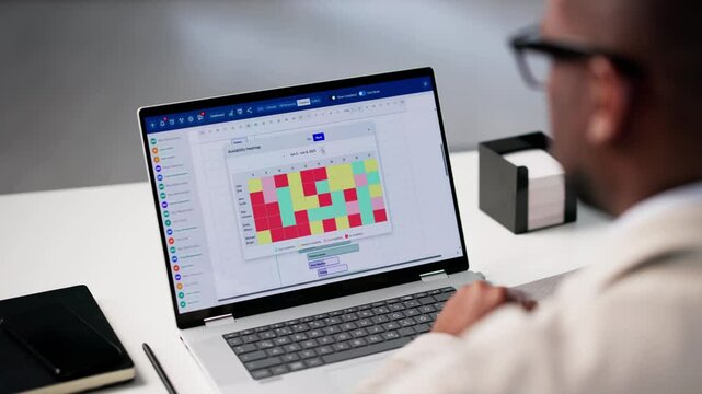 Project Manager Looking At Resource Availability Heatmap