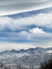 Snow covered mountains in Kyrgyzstan under cloudy winter sky peaceful rural landscape