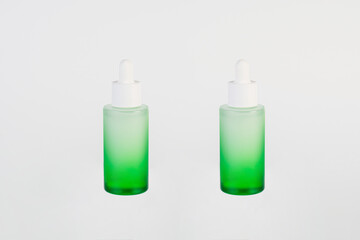 Green glass cosmetic bottle, Skin care or sunscreen cosmetic on white background.