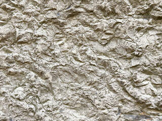 Close-up of rough textured stone surface with natural patterns