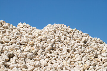 A pile of white rocks is on top of a hill