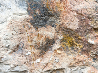 Colorful rock texture with natural patterns and mineral deposits