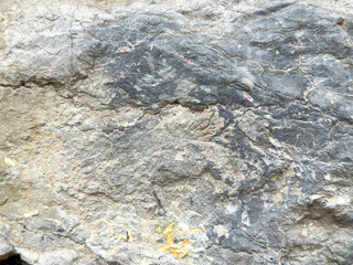 Rough natural stone texture with cracks and variations in color