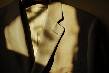 Beige suit jacket in the sunlight.