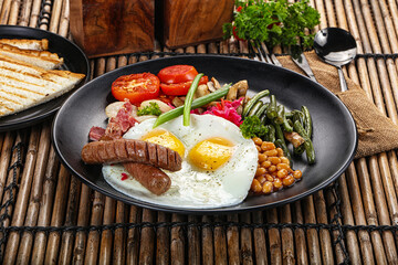 Traditional Engrlish breakfast with egg  and sausages