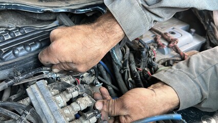 male mechanic repairing car engine