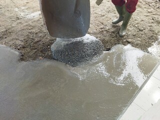 Manual cementing activity. No people's faces.