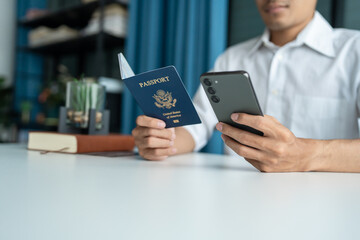 Hand Man Online booking and buying plane tickets using laptop phone and credit card Planning trip travel vacation with passport and ticket.